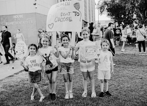 Little girls holding protest signs