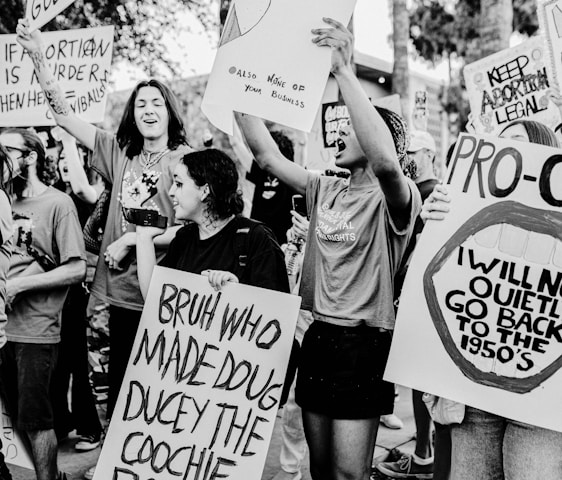 Young protesters holding signs